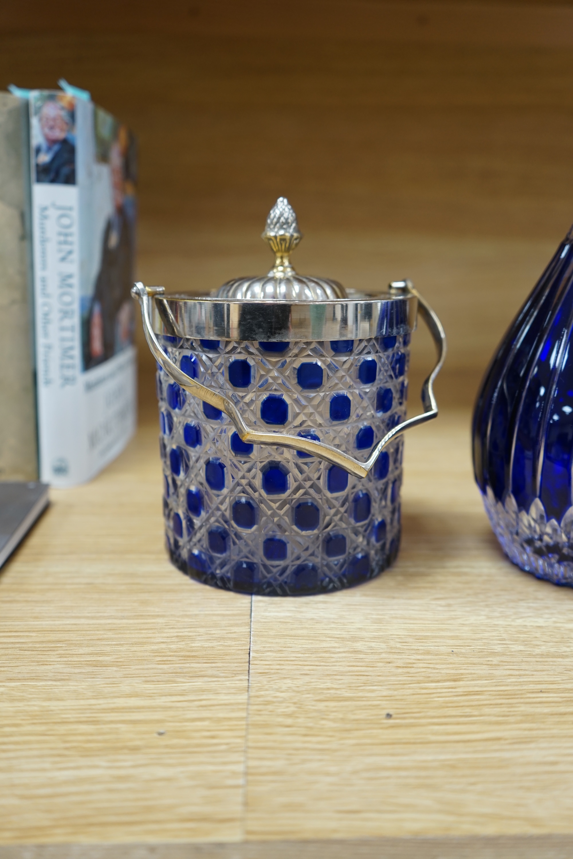 A collection of blue glassware comprising a late 18th century Bristol blue glass decanter and tear drop stopper, 30cm, a mid 19th century electroplate mounted blue glass decanter, a later Hungarian decanter and a similar